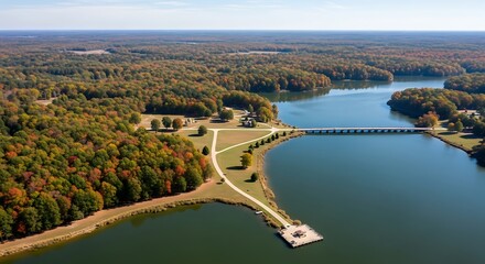 Vivid autumn colors reflected in a tranquil lake landscape from above
