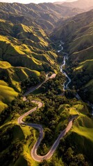 A winding road snakes through a valley of rolling hills, bathed in golden sunlight, creating a serene and picturesque landscape.