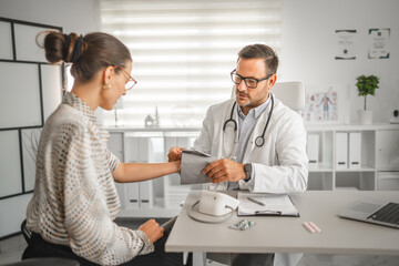Fototapeta premium Doctor preparing blood pressure cuff for patient checkup