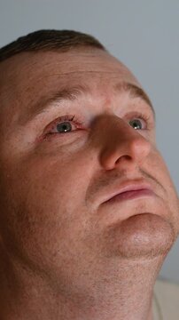 Makeup artist applying foundation on a man's face in studio