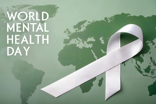 World mental health day with white ribbon on a green world map