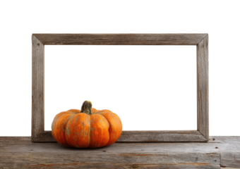 Autumn harvest with pumpkin in wooden frame on rustic table on a transparent background, cut out