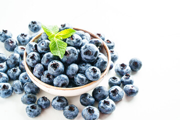 Blueberries in the bowl on white.