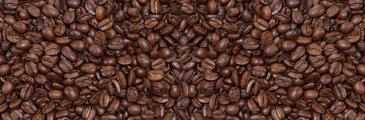 Scattered roasted coffee beans, full frame. Banner