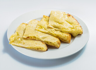 Homemade Cheese Naan slices in plate isolated on white background side view of a Traditional Indian Flatbread with Melted Cheese