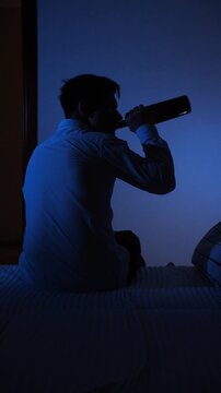 vertical video Man drinking alcohol alone struggling with addiction