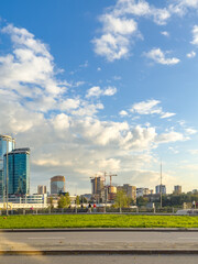 A cityscape with modern buildings and blue skies.