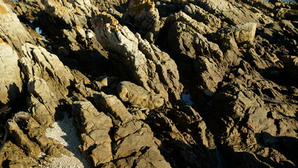 Rocky surface with natural texture and sharp formations, detailed geology background from coastal cliffs in South Africa
