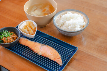Japanese breakfast with grilled salmon, natto, tofu, miso soup and rice
