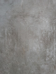 A textured grey surface with subtle variations in tone and a concrete-like appearance provides a modern and versatile backdrop for product presentations