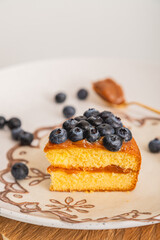 Cake Slice with Blueberries and Spoon of Caramel
