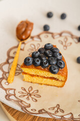 Cake Slice with Blueberries and Golden Spoon
