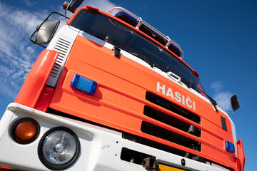 Fire engine and fire truck in the Czech Republic and Czechia. Czech text on the vehicle, translation: Fire fighters. Vehicle used by firemen and emergency service. Shallow focus.