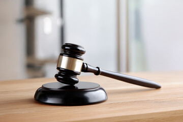 Wooden gavel resting on a smooth surface in a courtroom setting
