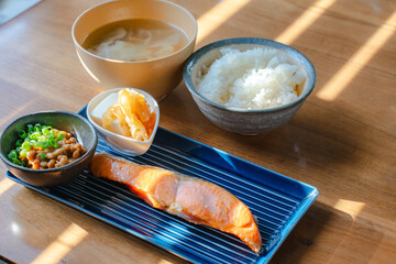 Japanese breakfast with grilled salmon, natto, tofu, miso soup and rice
