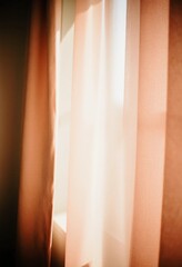 Sunlight gently streams through stylish curtains in warm brown, beige, and peach shades. The space feels cozy and inviting, perfect for relaxation and enjoying the afternoon light Generative AI