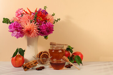 Autumn banner with a beautiful bouquet of dahlias in a vase, honey, apples, pomegranates, cinnamon and star anise on an elegant background, autumn greeting and thanksgiving concept,