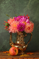 Autumn floral arrangement with dahlias in a vase, abstract still life with apples and flowers, Thanksgiving holiday banner, autumn greeting. Composition for a cozy mood
