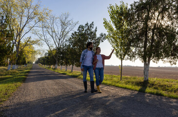 Fototapeta premium Farmer couple taking leisure walk and talking