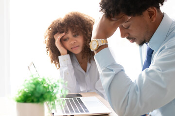 young business couple in the office with a stressed or lost expression
