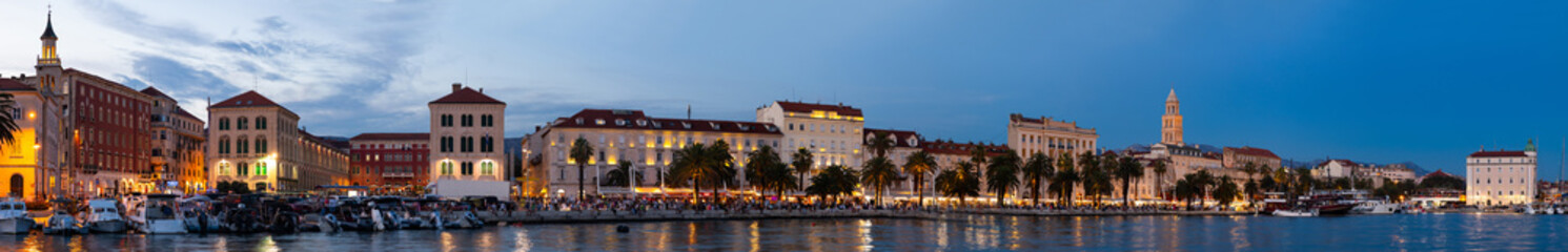 Summer evening on embankment of port city, panorama. On coast of Adriatic Sea is port of Split. Parking of watercraft in Adriatic Sea, parking place for yachts and ships...