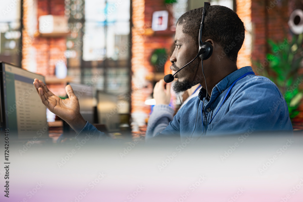 Poster call center staff member in office solving customers issues. african american man in customer suppor