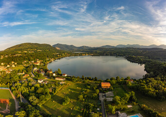 Aerial sunset view of Avigliana lake, Italy, Piedmont, Turin, Italy A beautiful town with and...