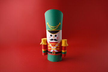 DIY Nutcracker toy project with paper and recycled toilet paper roll tube for classroom activity, product packaging, creative toy design, greeting content, or educational workshop branding,