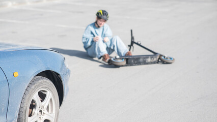 A Caucasian woman on a scooter after being hit by a car.