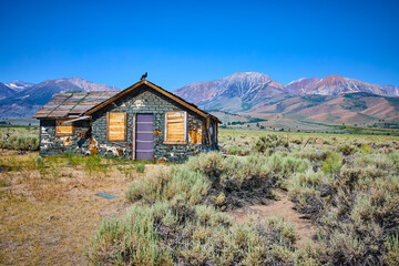 Abandoned House with Crow in Sagebrush Meadow and Sierra Nevada Mountains