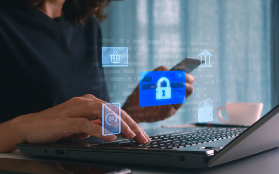 Woman using laptop and credit card with digital lock icon, concept of online payment security, internet banking, data protection, business financial transaction safety and cybersecurity in e-commerce.