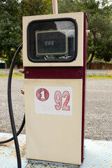 An old-fashioned gas station with mechanical hands and a meter. The gas station is located against the backdrop of the natural Altai mountains.