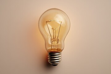 A glowing vintage light bulb against a pale background
