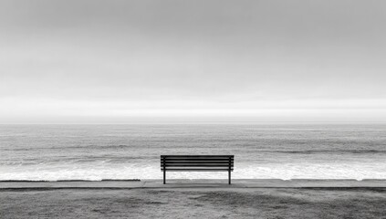 Empty bench by the sea in monochrome