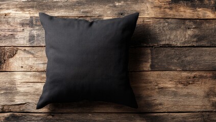 Black pillow on rustic wooden planks (1)