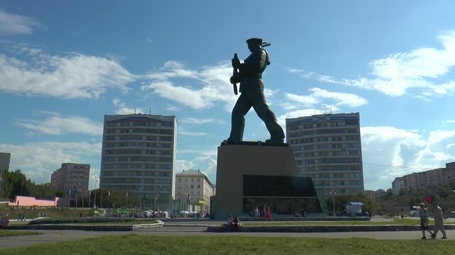 The monument to the heroes of nothern sea on the background of residential buildings and blue sky with clouds time lapse.