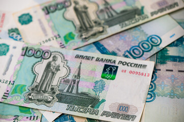 Russian 1000 ruble notes overlapping on wooden table