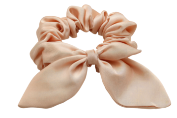 Peach-colored scrunchie with a bow, perfect for hair accessories. background removed