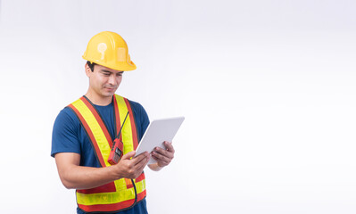 Handsome confident young craftsman wear yellow helmet hard hat safety with walkie talkie holding tablet standing over isolated white background. Maintenance workman occupation technology concept.