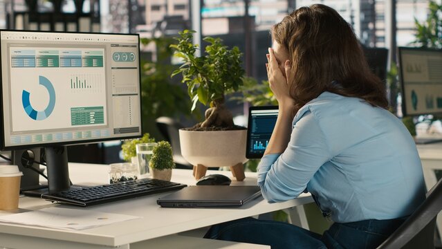 Employee at office desk getting upset after noticing mistake while editing documents, typing on keyboard. Overworked woman distraught by error committed while inputting data on laptop, camera A