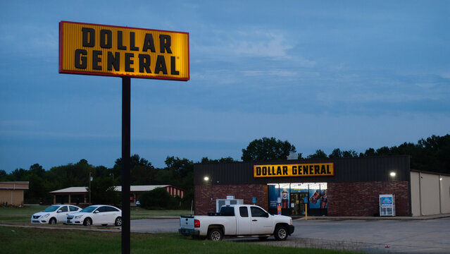 Dollar General, Sallisaw, Oklahoma, exterior with lighted signs at dawn or dusk.
