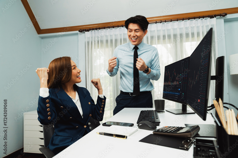 Poster successful smiling asian business partners raising fist up together in profitable project job in sto