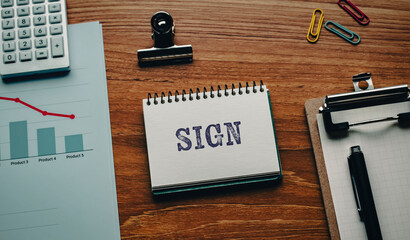 There is notebook with the word SIGN. It is as an eye-catching image.