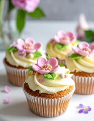 Delicate cupcakes adorned with pink floral decorations