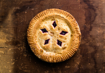 Rustic cherry pie with milk on wooden background, homemade dessert style