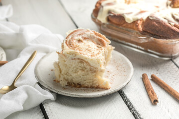 Cinnamon rolls with icing on white wooden boards, sweet homemade pastry