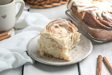 Cinnamon rolls with icing on white wooden boards, sweet homemade pastry