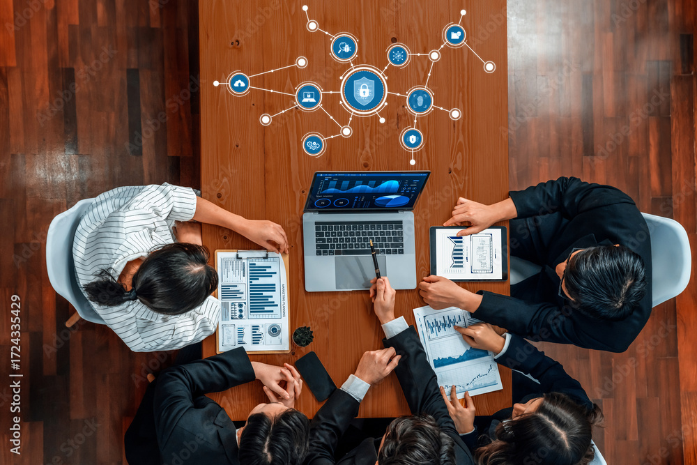 Poster a diverse team gathers around a table for a business meeting, discussing security strategies while r