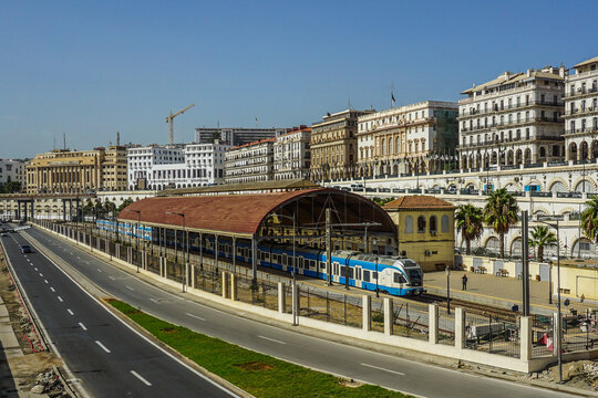 Scenic Railway View in Algiers: SNTF Train at the Historic Waterfront Station and Colonial Architecture