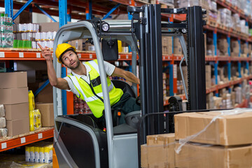 forklift is lifting wrapped pallet from upper shelf in warehouse, with blue and orange racks